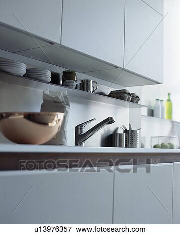Stock Photo - Close-up of copper bowl on worktop in modern white kitchen. Fotosearch