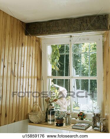 Stock Photograph - Close-up of cottage window in kitchen with tongue+groove panelling. Fotosearch