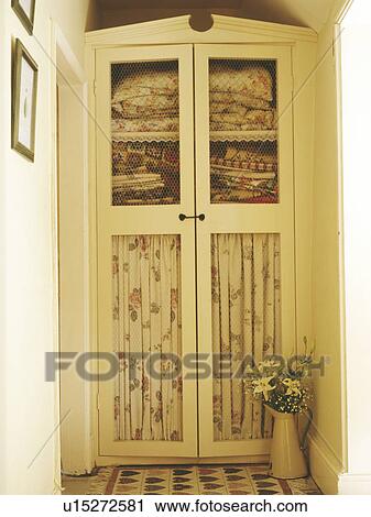 Close-up of cream built-in cupboard with internal drapes View Large Photo Image Stock Image - Close-up of cream built-in cupboard with internal drapes. Fotosearch