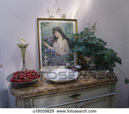 Close-up of Edwardian portrait and green houseplant on antique console table View Large Photo Image Stock Photo - Close-up of Edwardian portrait and green houseplant on antique console table. Fotosearch