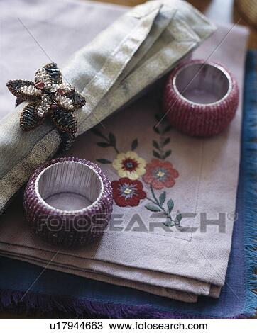 Close-up of embroidered table napkins with jewelled napkin rings View Large Photo Image Stock Image - Close-up of embroidered table napkins with jewelled napkin rings. Fotosearch