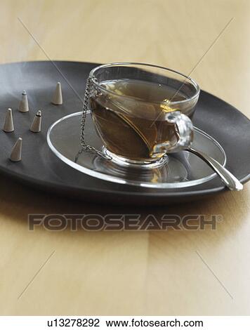 Close-up of glass tea-cup on black tray View Large Photo Image Stock Image - Close-up of glass tea-cup on black tray. Fotosearch