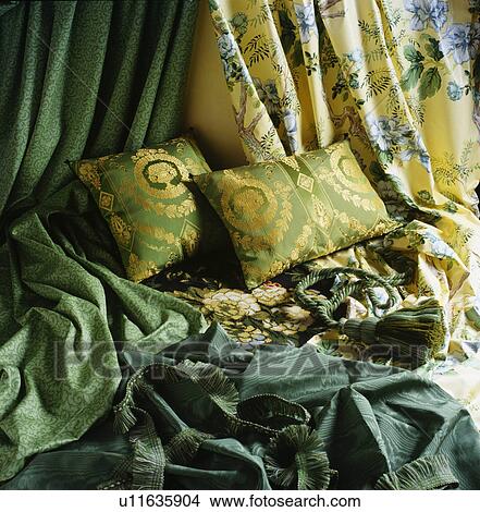 Picture - Close-up of grey silk and patterned curtains and cushions. Fotosearch