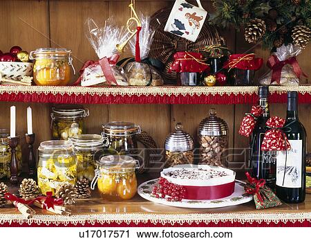 Close-up of home-made preserves and roasted nuts in glass jars on shelves with Christmas cake and bottles of wine View Large Photo Image Stock Image - Close-up of home-made preserves and roasted nuts in glass jars on shelves with Christmas cake and bottles of wine. Fotosearch