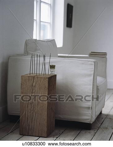 Close-up of incense on wooden block beside armchair with white loose-cover View Large Photo Image Stock Image - Close-up of incense on wooden block beside armchair with white loose-cover. Fotosearch