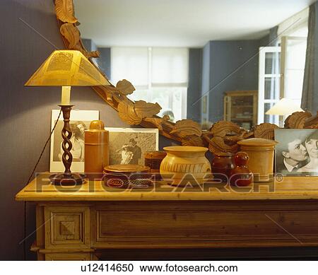Close-up of lighted lamp on pine table with collection of Treen pots View Large Photo Image Stock Image - Close-up of lighted lamp on pine table with collection of Treen pots. Fotosearch