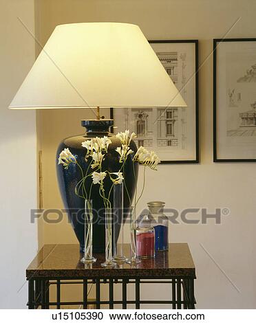 Close-up of lighted lamp on small black table View Large Photo Image Stock Image - Close-up of lighted lamp on small black table. Fotosearch