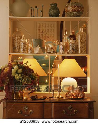 Close-up of lighted lamps and Christmas baubles with floral arrangement on shelves View Large Photo Image Stock Photo - Close-up of lighted lamps and Christmas baubles with floral arrangement on shelves. Fotosearch