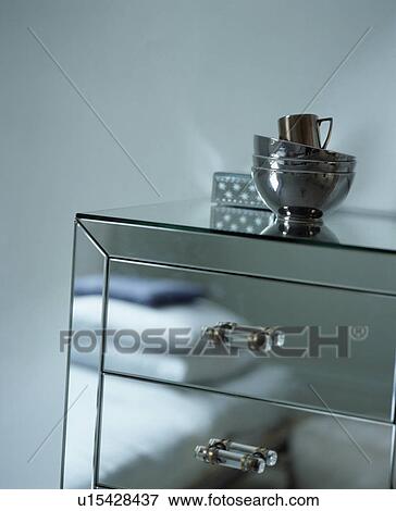 Stock Photo - Close-up of mirrored chest-of-drawers. Fotosearch