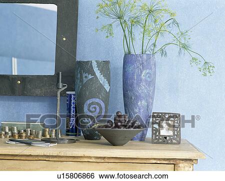 Stock Photograph - Close-up of modern grey and blue ceramic vases on console table. Fotosearch