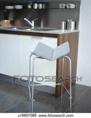 Stock Photo - Close-up of of metal stool in modern kitchen. Fotosearch