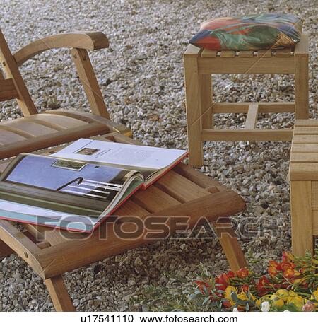 Close-up of open book on wooden chaise-longue View Large Photo Image Stock Image - Close-up of open book on wooden chaise-longue. Fotosearch