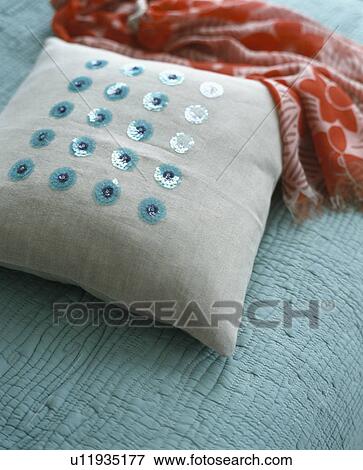 Close-up of pale grey cushions embroidered with turquoise sequins View Large Photo Image Stock Photo - Close-up of pale grey cushions embroidered with turquoise sequins. Fotosearch