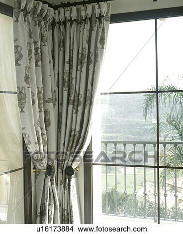 Picture - Close-up of patterned curtains at large window. Fotosearch