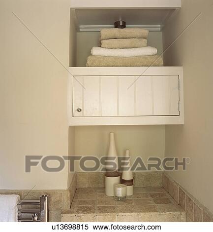 Close up of pile of towels on cupboard shelf in modern bathroom View Large Photo Image Stock Photography - Close up of pile of towels on cupboard shelf in modern bathroom. Fotosearch