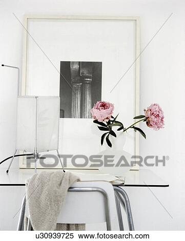 Close-up of pink paeonies on modern table below black and white picture on wall View Large Photo Image Stock Photography - Close-up of pink paeonies on modern table below black and white picture on wall. Fotosearch