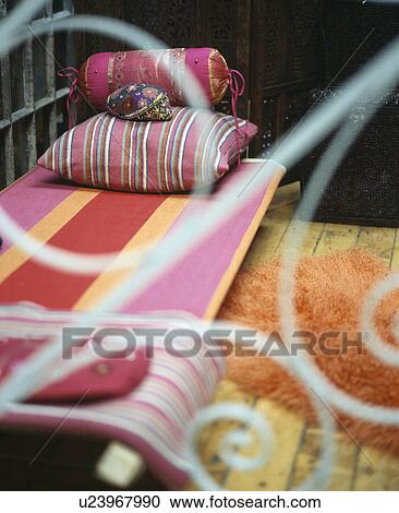 Close-up of pink striped cushions non metal day-bed View Large Photo Image Stock Image - Close-up of pink striped cushions non metal day-bed. Fotosearch
