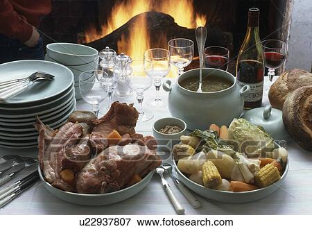 Close-up of plates of chops and vegetables on table with pale green crockery View Large Photo Image Stock Photo - Close-up of plates of chops and vegetables on table with pale green crockery. Fotosearch