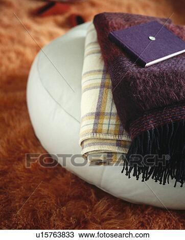 Close-up of purple and checked throws on white leather cushion View Large Photo Image Stock Image - Close-up of purple and checked throws on white leather cushion. Fotosearch