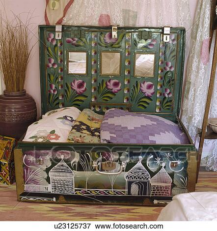 Stock Photo - Close-up of quilts in hand-painted and decorated tin chest. Fotosearch