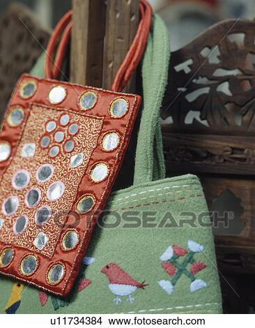 Picture - Close-up of red and green embroidered and mirrored backs. Fotosearch