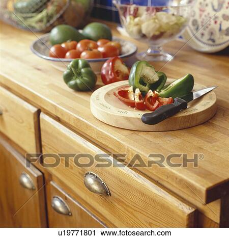 Close up of red and green peppers chopped on board on wooden kitchen worktop View Large Photo Image Stock Image - Close up of red and green peppers chopped on board on wooden kitchen worktop. Fotosearch