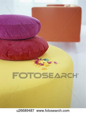 Close-up of red and pink cushions on modern yellow upholstered stool View Large Photo Image Stock Photo - Close-up of red and pink cushions on modern yellow upholstered stool. Fotosearch