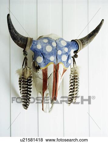Stock Photo - Close-up of skeleton cow's head painted in blue spots and red stripes. Fotosearch