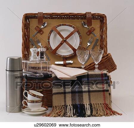 Stock Photo - Close-up of Thermos flask and checked rug with traditional picnic basket. Fotosearch