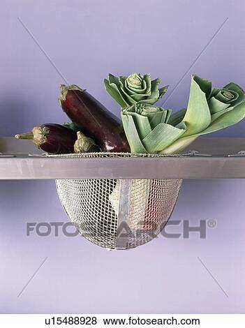 Close-up of vegetables in steel basket in stainless steel shelf View Large Photo Image Stock Photo - Close-up of vegetables in steel basket in stainless steel shelf. Fotosearch
