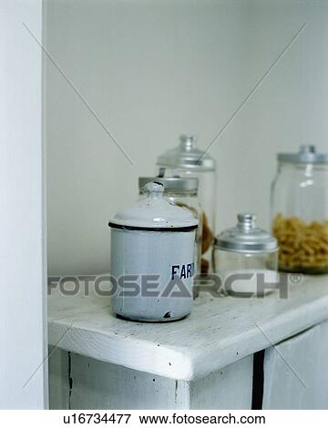 Stock Photo - Close-up of white enamelled French storage tin. Fotosearch