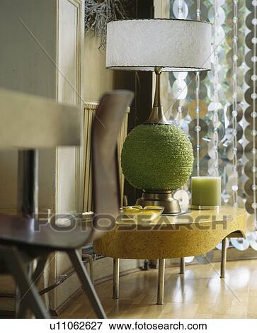 Close-up of white lampshade on green beaded base on modern coffee table View Large Photo Image Stock Photo - Close-up of white lampshade on green beaded base on modern coffee table. Fotosearch