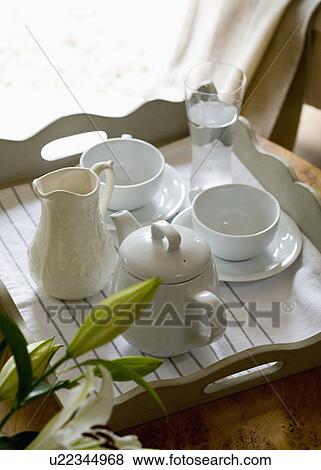 Close-up of white teapot and cups with jug on wooden tray View Large Photo Image Stock Photo - Close-up of white teapot and cups with jug on wooden tray. Fotosearch