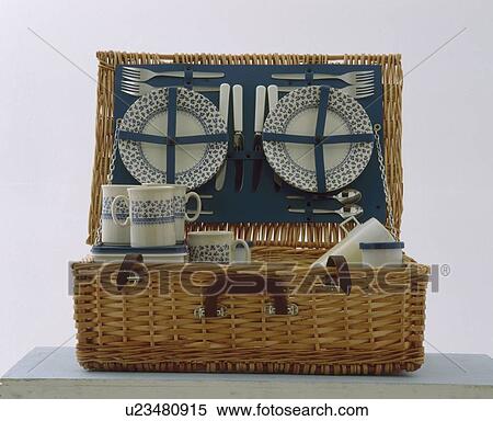 Stock Photography - Close-up of wicker picnic basket with blue+white crockery. Fotosearch