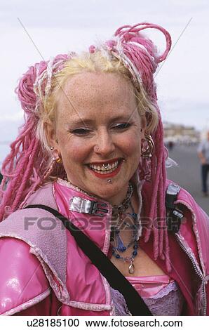 Close up of young woman with face piercings and pink dreadlocks View Large Photo Image Stock Image - Close up of young woman with face piercings and pink dreadlocks . Fotosearch