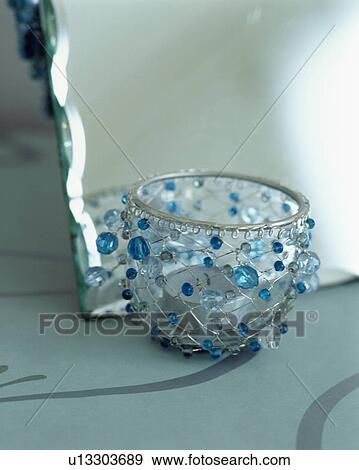 Close-up up glass votive jar decorated with blue glass beads View Large Photo Image Stock Photo - Close-up up glass votive jar decorated with blue glass beads. Fotosearch