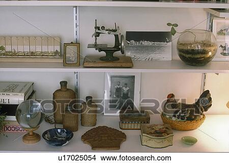 Collection of artefacts and old wicker bottles with vintage tin boxes on white shelves View Large Photo Image Picture - Collection of artefacts and old wicker bottles with vintage tin boxes on white shelves. Fotosearch