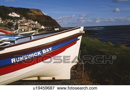 Colourful boats pulled up on the shore at Runswick Bay in Yorkshire View Large Photo Image Stock Photo - Colourful boats pulled up on the shore at Runswick Bay in Yorkshire. Fotosearch