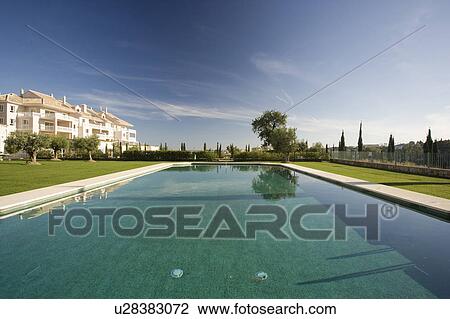 Stock Image - Communal swimming-pool situated in gardens in front of the villas.. Fotosearch