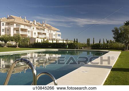 Stock Photograph - Communal swimming-pool situated in gardens in front of the villas.. Fotosearch