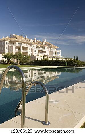 Communal swimming-pool situated in gardens in front of the villas. View Large Photo Image Stock Photograph - Communal swimming-pool situated in gardens in front of the villas.. Fotosearch