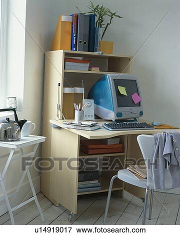 Computer on foldaway desk in modern home office View Large Photo Image Stock Photo - Computer on foldaway desk in modern home office. Fotosearch
