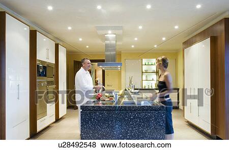 Couple in modern kitchen View Large Photo Image Stock Photo - Couple in modern kitchen. Fotosearch
