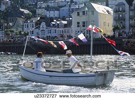 Couple in small wooden boat with colourful bunting in Dartmouth harbour View Large Photo Image Stock Photo - Couple in small wooden boat with colourful bunting in Dartmouth harbour. Fotosearch