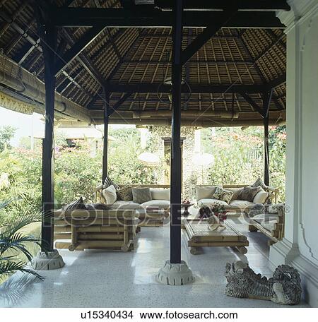 Cream cushions on bamboo sofas on veranda of traditional house in Bali View Large Photo Image Picture - Cream cushions on bamboo sofas on veranda of traditional house in Bali. Fotosearch