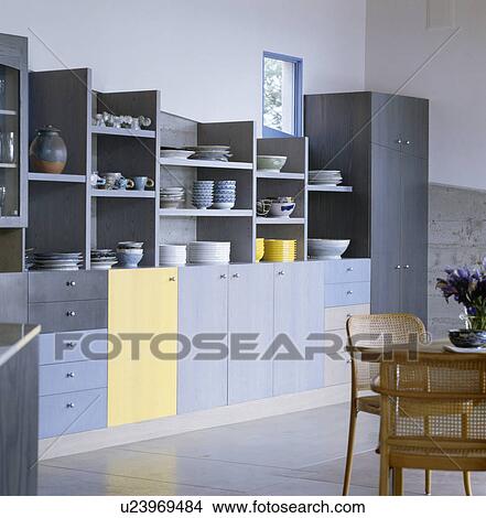 Crockery on open shelves in modern kitchen with pale blue fitted units View Large Photo Image Picture - Crockery on open shelves in modern kitchen with pale blue fitted units. Fotosearch