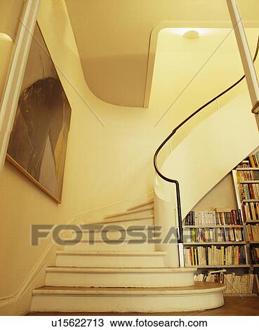 Curved staircase with half-wall in cream hall View Large Photo Image Stock Image - Curved staircase with half-wall in cream hall. Fotosearch