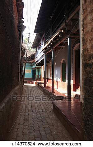 Picture - Dark shady alleyway between houses in Indian town.. Fotosearch