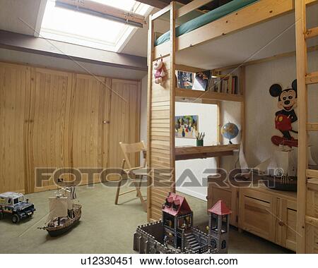 Desk Below Platform Bed In Child S Attic Bedroom Stock Image