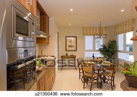 Dining table and chairs in kitchen on corner of building. View Large Photo Image Stock Photograph - Dining table and chairs in kitchen on corner of building.. Fotosearch